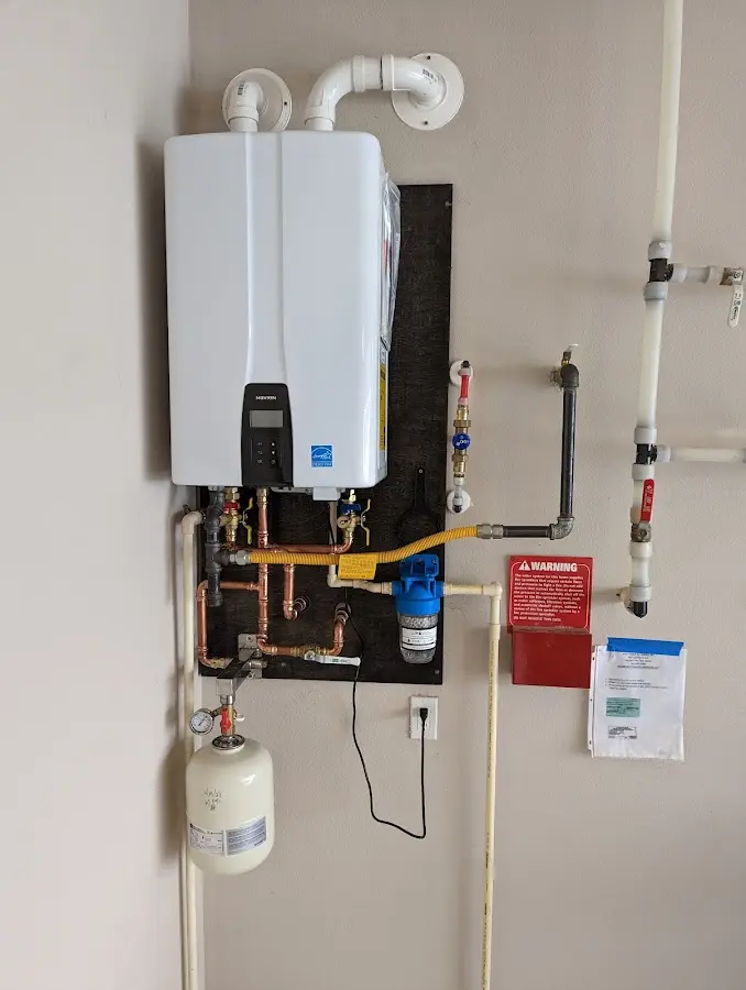 Professional plumber installing copper piping in a Falmouth home